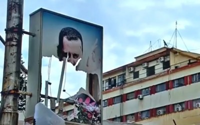 The gunman who tore up Assad's picture in Qamishli did that three years ago.