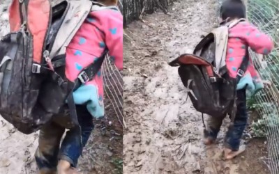 What is the origin of the video showing the kid going to school in the mud?
