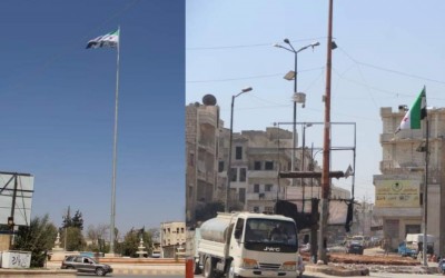 هل استبدلت هيئة تحرير الشام راياتها في إدلب بـ "علم الثورة السورية"؟